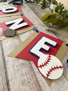 paper cut out baseballs and letters on a table