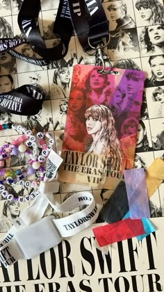 an advertisement for taylor swift the eras tour is displayed on a table with other items