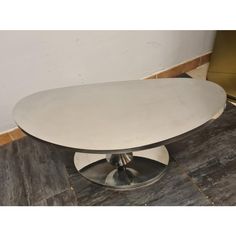 a round white table sitting on top of a wooden floor