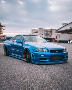 a blue car is parked in a parking lot