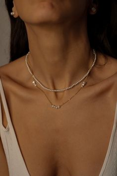 Freshwater Pearl Necklace Simple and feminine! This timeless classic piece can perfectly be layered with other necklaces or pendants. A great gift for yourself or a loved one. Pearl necklace style: ♦️ natural freshwater pearl choker 16"+2" extender chain ♦️ floating pearl necklace 16"+2" extender chain Details: * Pearl size: around 3mm * Material: natural white freshwater pearls, 18k gold-plated over stainless steel * Length:16"+2" chain extender * Waterproof Pearls are known for their calming e Elegant Layered Pearl Necklace, Elegant Pearl Layered Necklace With Pearl Chain, Elegant White Pearl Layered Necklace, Elegant Layered Pearl Necklace As Gift, Elegant Pearl Layered Necklace As Gift, Elegant Pearl Layered Necklace Gift, Elegant Pearl Layered Necklace With Delicate Chain, Silver Layered Necklace For Wedding, Silver Layered Clavicle Chain Necklace For Wedding