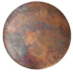 a round metal plate with an artistic design on the top and bottom, against a white background