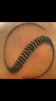 an image of a spiral tattoo on the back of a man's upper arm