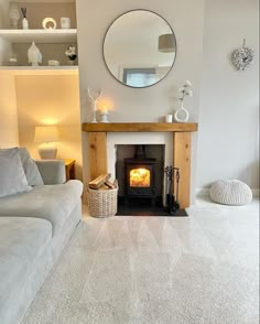 a living room filled with furniture and a fire place next to a wall mounted mirror