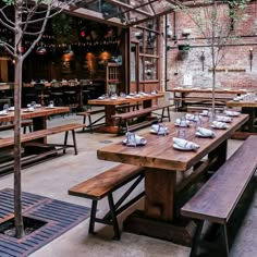 an outdoor dining area with wooden tables and benches