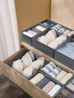 two drawers filled with folded pillows and blankets