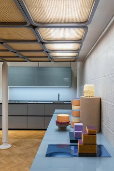 an empty kitchen is shown with blue counter tops and white walls, along with wooden flooring