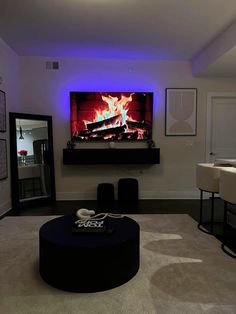 a living room filled with furniture and a flat screen tv mounted to the side of a wall