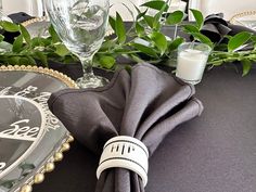 the table is set with napkins, glasses and silverware for an elegant dinner