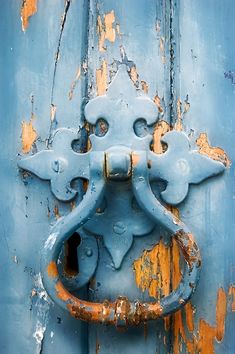 an old blue door with rusted metal handle on it's front and side