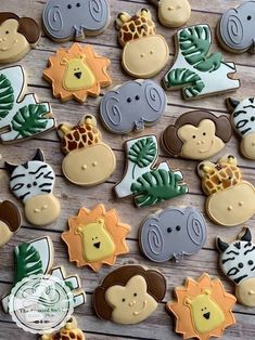 many decorated cookies with animals and giraffes on them