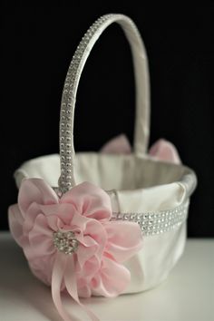 a white basket with pink flowers on it