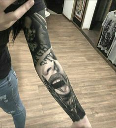 a person with a black and white tattoo on their arm