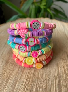 a stack of colorful hair clips sitting on top of a wooden table