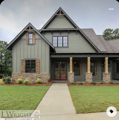 a gray house with brown shutters on the front and side windows is shown in this image