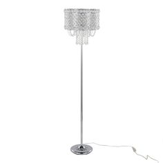 a chrome floor lamp with crystal beads on the base and a white cord plugged in