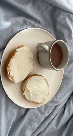 two pieces of bread on a plate next to a cup of coffee