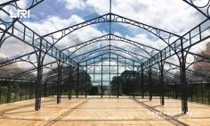 the inside of a glass building with lots of windows and wood flooring on it