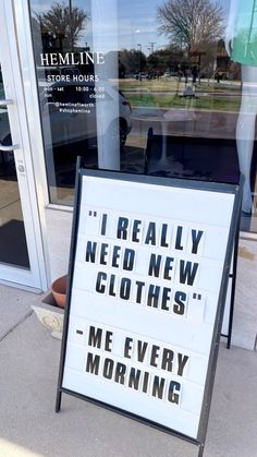 a sign in front of a store that says i really need new clothes me every morning