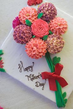 a birthday cake decorated with flowers and the words happy mother's day