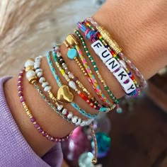 several bracelets are stacked on top of each other, with the word funky written on them