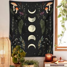 a tapestry hanging on the wall next to a potted plant