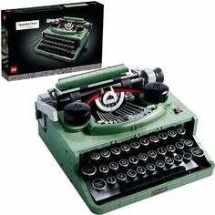 an old fashioned green typewriter with its box open