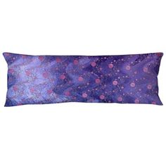 a purple and pink rectangular pillow with small dots on the front, sitting on a white surface