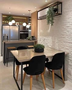 a dining room table with chairs and an oven in the background, next to a kitchen