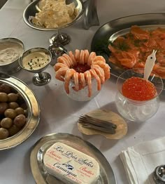 a table topped with lots of different types of food and condiments on top of it