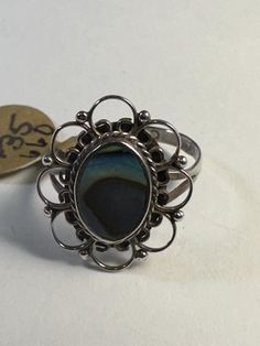 This is such a sweet vintage sterling ring with abalone Shell inlay. It features delicate filigree around the center stone. Size is 4 1/2 and is sizeable for a fee. PLEASE NOTE THAT ANY ORDERS EXPECTED BY CHRISTMAS SHOULD BE PLACED BY 12/13/24. Abalone Ring, Abalone Shell, Solitaire Ring, Sterling Ring, Sterling Silber, Vintage Sterling Silver, Jewelry Rings, Shells, Sterling Silver