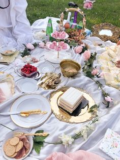 an outdoor picnic with desserts and snacks on the table