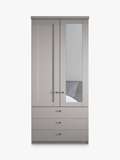 a white armoire with mirrored doors and drawers