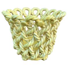 an abstract sculpture made out of yellow and white yarn on a white background with clipping for text