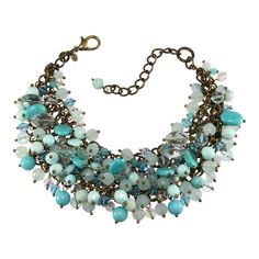 This is part of Chairish’s Costume Jewelry assortment.  Sequin Brand statement necklace with oodles of dangling crystal and glass beads including ovals that simulate turquoise. Colors include turquoise blue, light blue, opalescent blue and iridescent clear. The necklace is made up of a loose metal mesh backing in brassy antiqued gold with beads attached. Marked Sequin. Measures about 2" wide; chain adjusts from 14" to 17” long. Purchased at Neiman Marcus in late 1990s to early 2000s. Excellent c Luxury Blue Turquoise Necklace With Colorful Beads, Brand Statement, Turquoise Faceted Multi-strand Beaded Necklaces, Blue Gemstone Multi-strand Necklaces, Luxury Multi-strand Turquoise Beaded Necklaces, Blue Beaded Multi-strand Crystal Necklace, Beaded Statement Necklace, Metal Mesh, Early 2000s