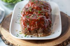 meatloaf covered in sauce and garnished with parsley on a plate