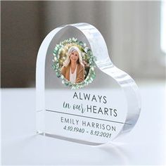 a heart shaped glass plaque with a photo on it