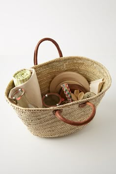 a basket filled with lots of items on top of a white table