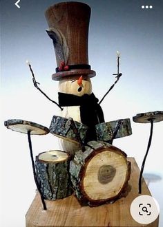 a snowman made out of wood with musical instruments