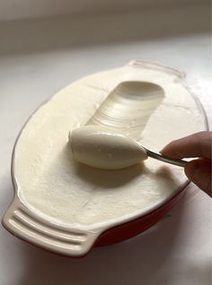 a spoon in a container filled with yogurt