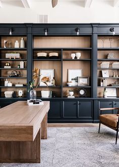 a living room filled with furniture and lots of shelves