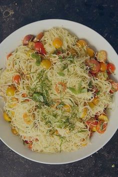 a white bowl filled with pasta and vegetables