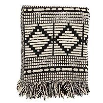 a black and white blanket with fringes on it