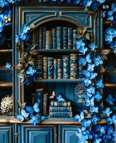 a book shelf with blue flowers on it and bookshelves in the back ground