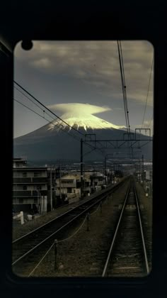 a train track with a mountain in the background