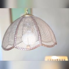 a close up of a light fixture with a blurry image in the back ground