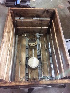 an old wooden box filled with pots and pans