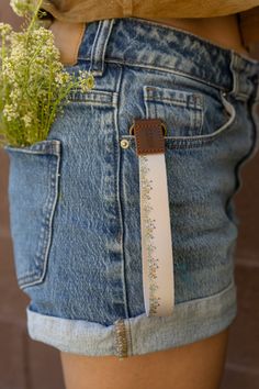 a woman's waist with a flower in her pocket and a ruler attached to it