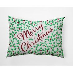 a merry christmas pillow with holly leaves on it