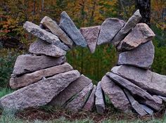 a heart made out of rocks in the grass